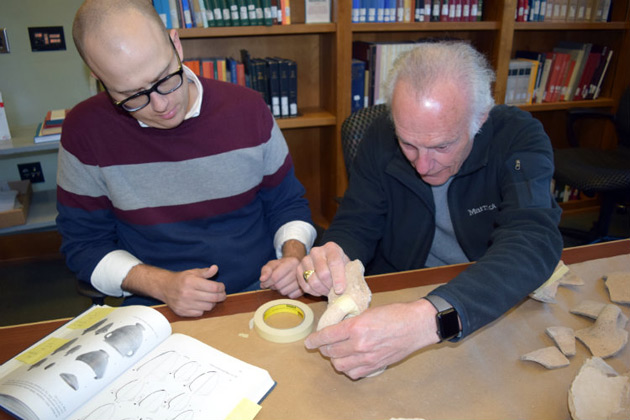 L-r: Jonathan Redding, a doctoral student in religion, and Emeritus Professor Douglas Knight sort through pottery fragments recovered from an archaeological dig at Megiddo. (Vanderbilt University)