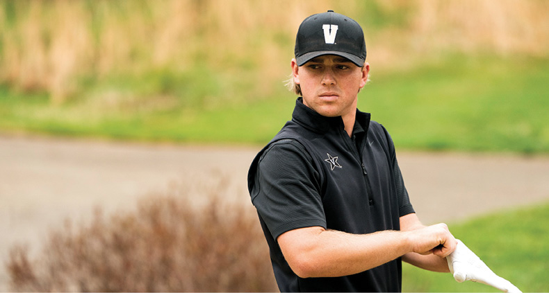 photo of John Augenstein putting on a glove while on a golf course